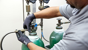 Using gas handling equipment and accessories, an Airgas Healthcare technician safely installs cylinders at the point of use in a healthcare facility.