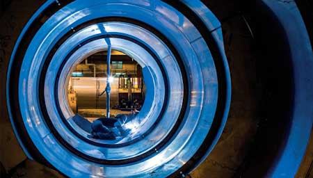 Welder, welding the inside of a giant pipe