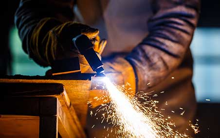 Plasma cutting a steel sheet.