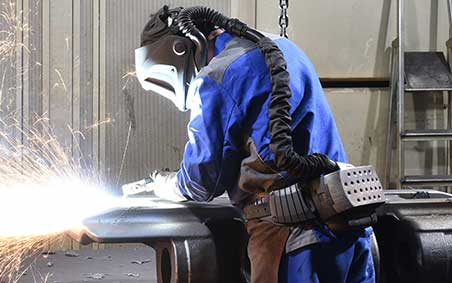 A welder in an inclosed space using S.C.B.A. gear to protect themselves from the fumes