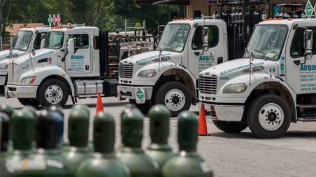 A line of Airgas delivery trucks