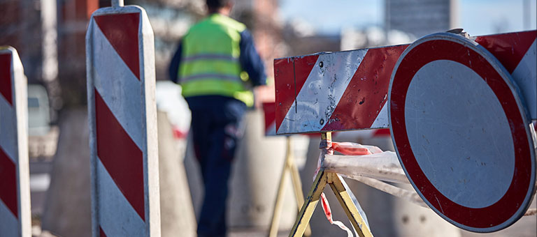 Caution signs closing a road for construction work