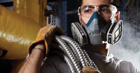 A worker in a dusty environment wearing a 3M Respirator