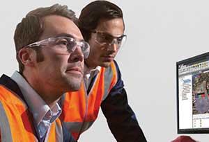 Two workers wearing Honeywell eye protection